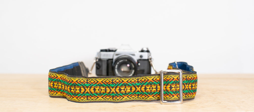 skinny camera strap in shades of yellow, orange, and green